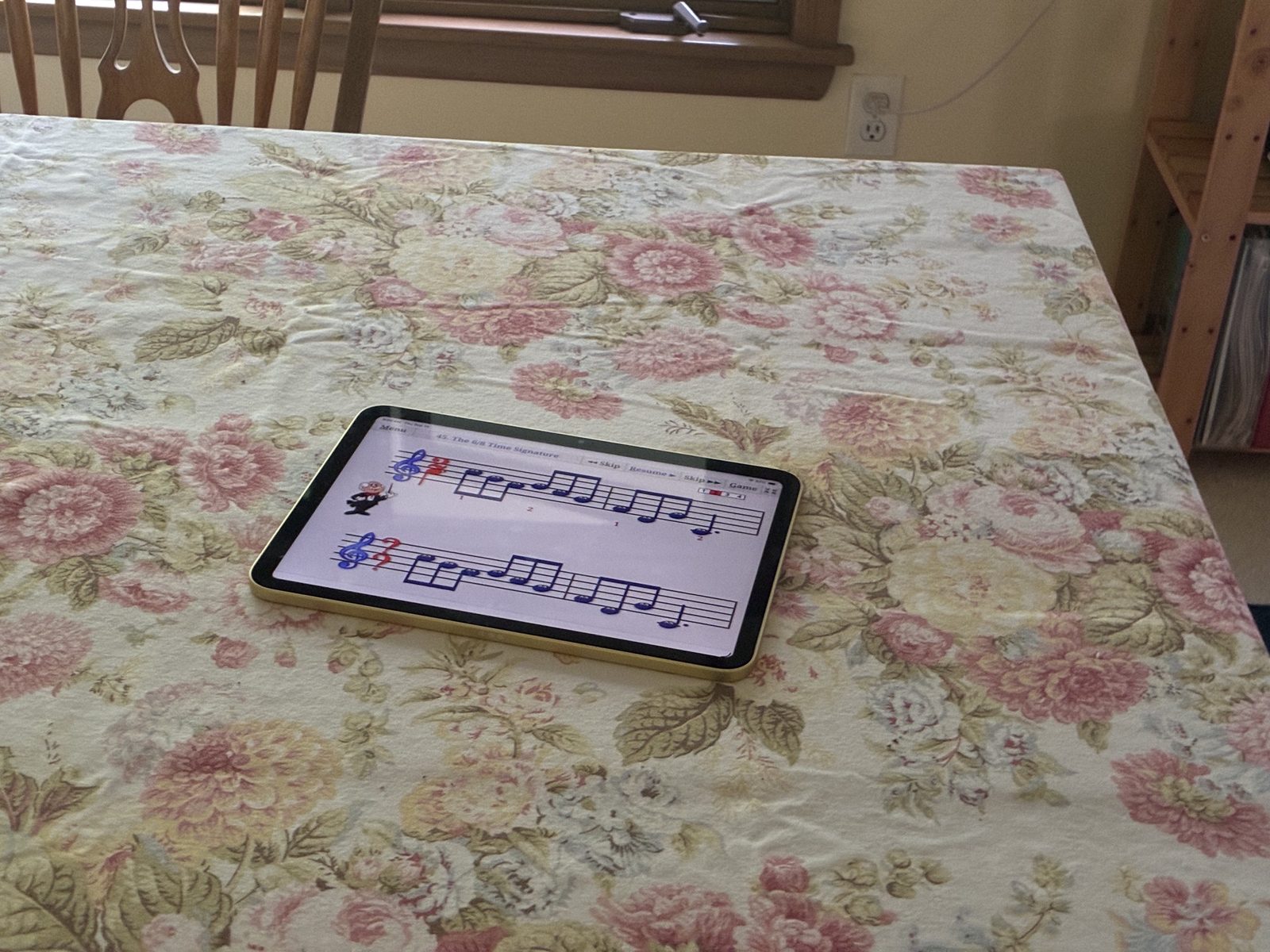 A Music Ace lesson on an iPad, on a kitchen table